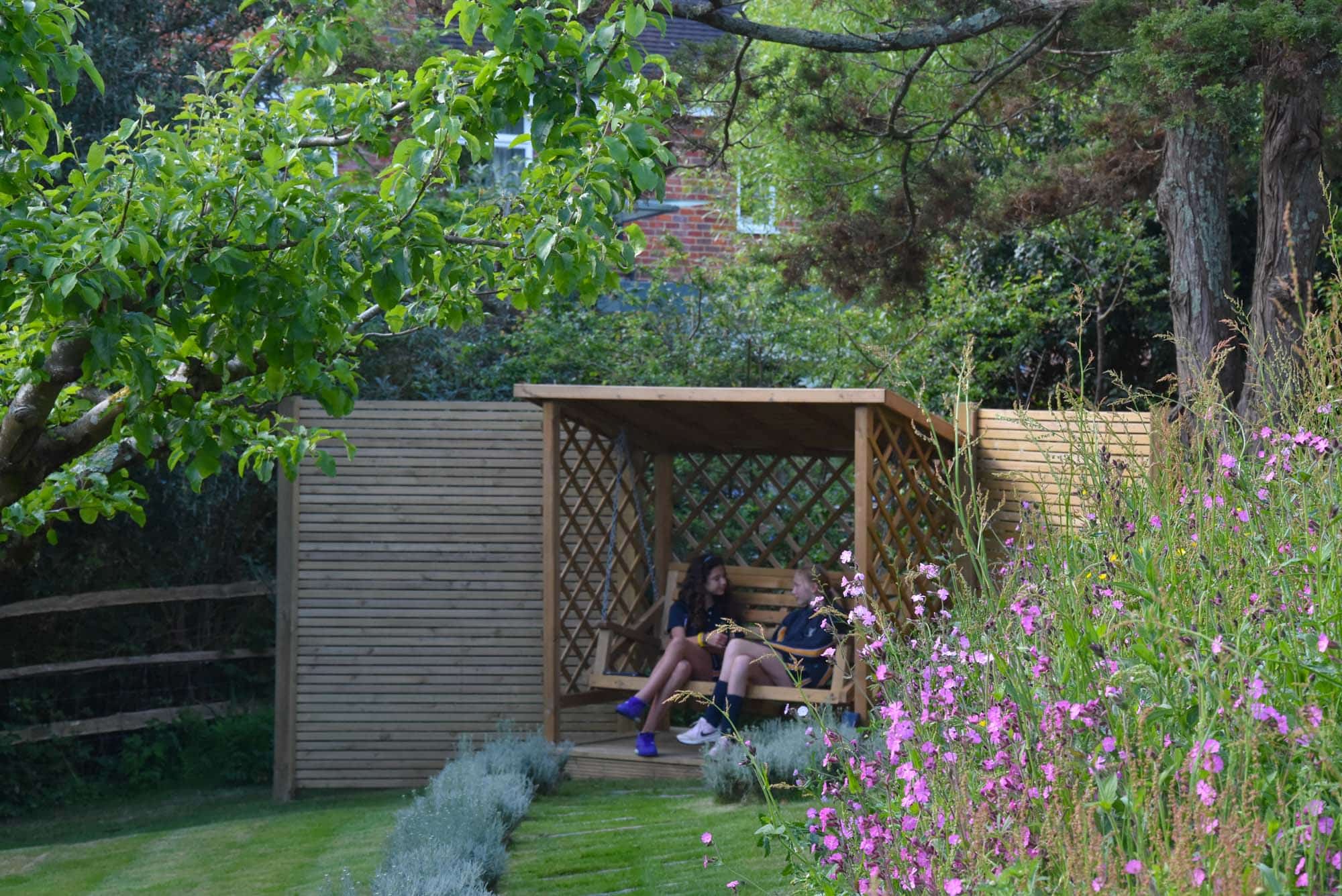 Students relaxing in the Wellbeing Garden